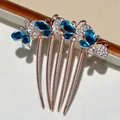 Rose gold butterfly hair comb featuring deep blue rhinestones and crystal accents - Blue