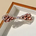 Fermaglio per capelli a fiocco in cristallo ambrato con base dorata e strass - Champagne