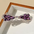 Elegante fermaglio per capelli a fiocco con cristalli viola e strass bianchi su base oro - Viola