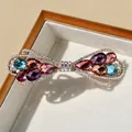 Barrette à cheveux dorée en forme de nœud avec cristaux colorés et strass scintillants - Multicolore