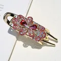 Molla per capelli a fiori dorata con strass rosa e cristalli rossi su fondo bianco - Rosso