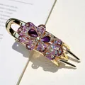 Elegante fermaglio a farfalla dorato con strass viola e grandi gemme a goccia - Viola
