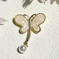Golden butterfly brooch with pearlescent shell wings and a round white pearl drop - Swallowtail Butterfly