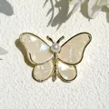 Elegant gold butterfly brooch with iridescent wings and center pearl embellishment - Cabbage Butterfly