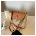 Handwoven straw shoulder bag with brown faux leather strap and golden rivet detail - One Size / Beige
