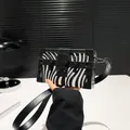 Fashionable box bag with zebra print pattern and black leather trim accents - Zebra Print