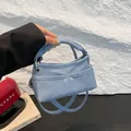 Light blue denim handbag with two front pockets and chic cylindrical top handles - Light Blue