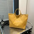 Large yellow textured tote bag with white TOTE BAG print on a modern metal stand - One Size / Yellow
