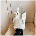 Weiße Eimertasche aus PU-Leder mit geprägten Buchstaben und gewebtem Anhänger - Weiß