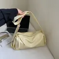 Elegant cream soft leather underarm bag with adjustable strap and tassel zipper detail - Yellow