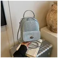 Mini light blue denim backpack with silver chain strap and twist-lock pocket detail - One Size / Silver