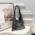 Black faux leather handbag with diverse silver rivets and chic punk shoulder strap - Black