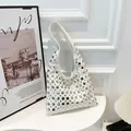 White faux leather hobo shoulder bag with stylish silver stud details and a wide strap - White