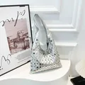 Silver shoulder bag with metallic studs in a trendy crescent motorcycle style - Silver