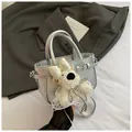 Detail of silver metallic textured handbag with a cute white teddy bear plush charm - Silver With Pendant
