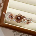 Handmade flower spring clip with brown gauze petals and rhinestones on rose gold base - Champagne