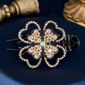 Elegant black hair claw clip with champagne and white rhinestone four-leaf clover design - Lilac Yellow