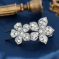 Elegant floral hair claw clip featuring black base with sparkling white and iridescent rhinestones - Begonia White