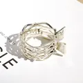 Golden round claw clip with woven hollow pattern and elegant white faux pearls - Hollow Pearl Style
