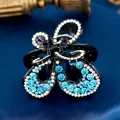 Elegant butterfly hair claw clip with light blue rhinestones on a black acrylic base - Butterfly Blue