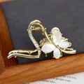 Pinza per capelli a farfalla dorata con pietre opali bianche e accenti di cristallo - Volo della Fenice