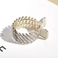 Gouden haarklem in vogelneststijl met fonkelende steentjes voor een hoge paardenstaart - Strass Twill Stijl