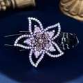 Elegant floral hair claw clip with purple rhinestones on a dark satin background - Star Flower Purple