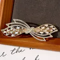 Elegante pinza de pelo mariposa dorada con brillantes de imitación blancos y muelle - Lazo Flotante de Zirconia