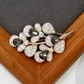 Rose gold flower branch brooch with black gemstones and crystals on wood background - Graphite Crystal Leaf