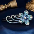 Elegant black alloy hair claw clip with blue rhinestone flowers on blue silk background - Large Pear Flower Blue