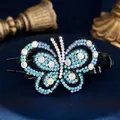Elegant butterfly hair claw clip with blue rhinestones on a velvet background - Double Butterfly Blue