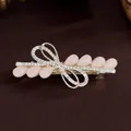Fermaglio per capelli dorato con pietre in resina rosa e strass bianchi scintillanti - Pesca Chiaro