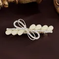 Fermaglio per capelli dorato con strass brillanti e dettagli in resina a forma di foglia - Giallo Mandorla