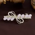 Fermaglio a fiocco dorato con gemme viola a goccia e strass brillanti incastonati - Lilla