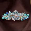 Elegant gold flower hair clip with deep blue rhinestones and iridescent center stone - Five-Petal Flower Blue