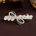 Barrette à ressort dorée avec nceud, gouttes de résine colorées et strass incrustés - Multicolore