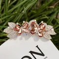 Golden butterfly hair clip with amber rhinestones and crystal details on grass - No. 2 Yellow