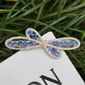 Elegant gold bow hair clip featuring deep blue rhinestones and white crystals - Blue