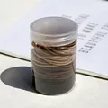 Coleteros marrón tierra de alta elasticidad en un frasco de almacenamiento minimalista - Serie Café