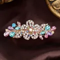 Elegant gold flower hair clip with multi-colored crystals on dark satin background - Colorful Five Petal Flower