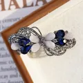 Elegante fermaglio in lega d'argento con pietre blu e perle bianche dal design a fiocco - Fiore Farfalla Blu Reale