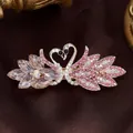Golden spring hair clip featuring heart-shaped twin swans with pink and purple crystals - Crystal Swan Red