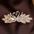 Zwaan haarklem met champagne kristallen en strass steentjes op gouden legering basis - Kristallen Zwaan Geel