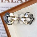 Fermaglio floreale con cristalli champagne e pietre bianco opaco in argento vintage - Papillon Piccolo Champagne