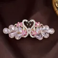 Rose gold swan hair clip with pink crystals and heart shape design for women - Glass Swan Red