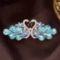Elegant blue crystal swan hair clip with rose gold finish and intricate rhinestones - Glass Swan Blue