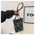 Chic black and grey patterned phone bag with m letter logo and slim knotted shoulder strap - Black / One Size