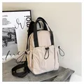 Minimalist cream nylon backpack with black drawstring pocket and durable black straps - One Size / White