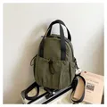 Olive green pleated nylon backpack with drawstring front pocket and black web handles - One Size / Green