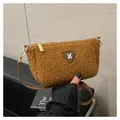 Brown faux fur crossbody bag with leather strap and decorative logo tag on plush surface - With Pendant / Brown
